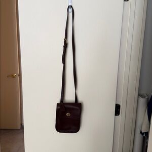 Coach vintage small brown leather crossbody bag with long adjustable strap.